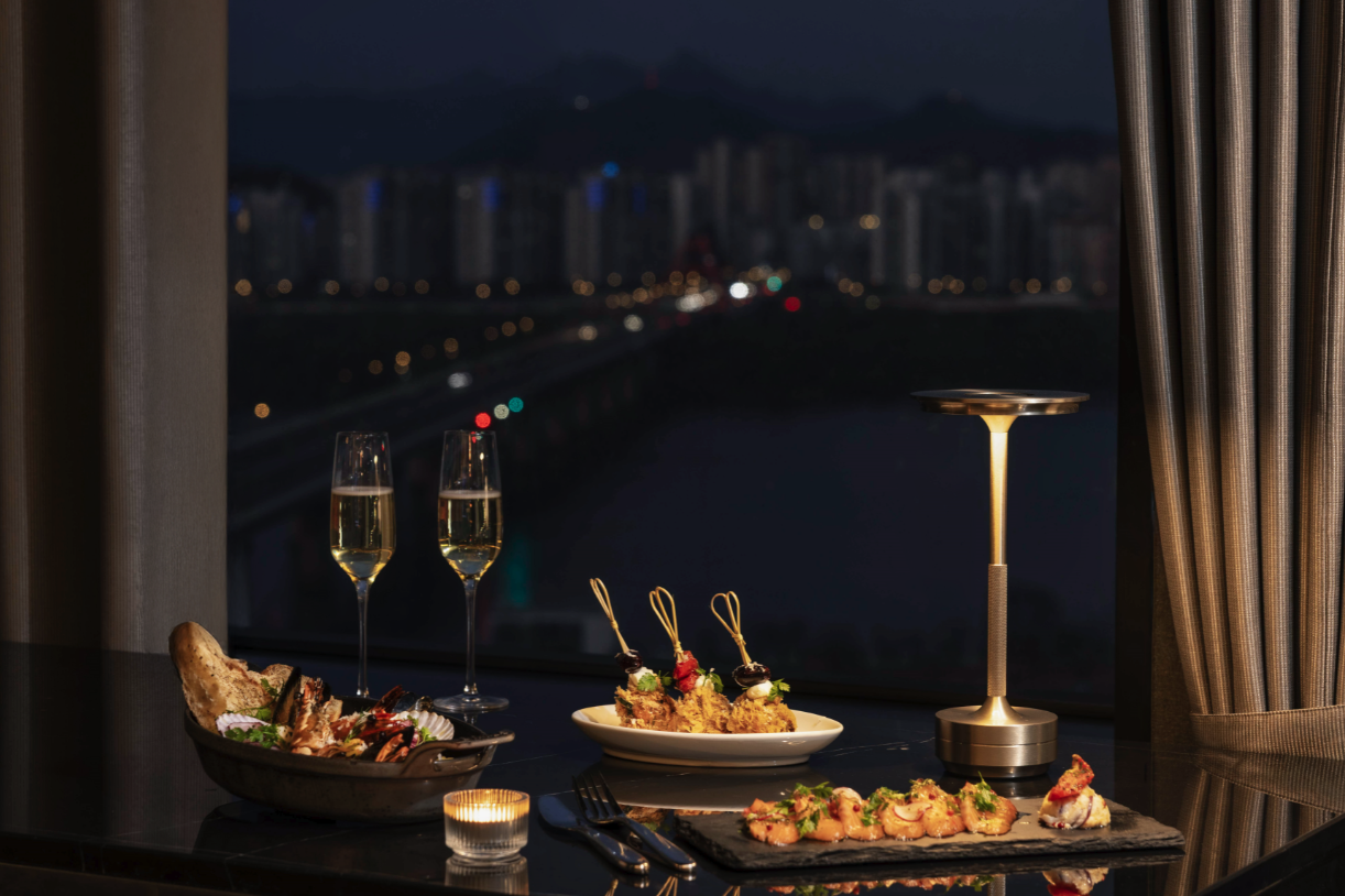 Han River fine dining Seoul - candlelit riverside restaurant table with Han River panorama at dusk